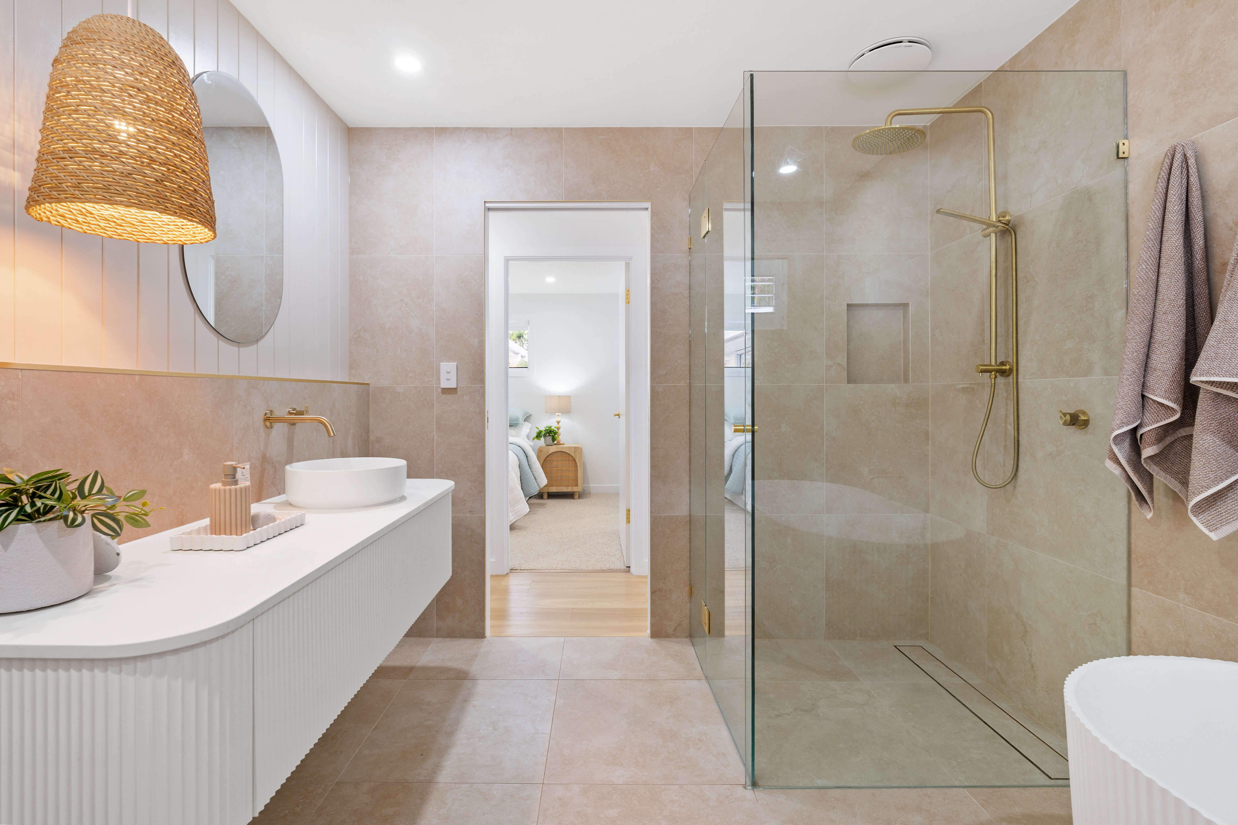 Luxury bathroom with gold tapware and fluted vanity