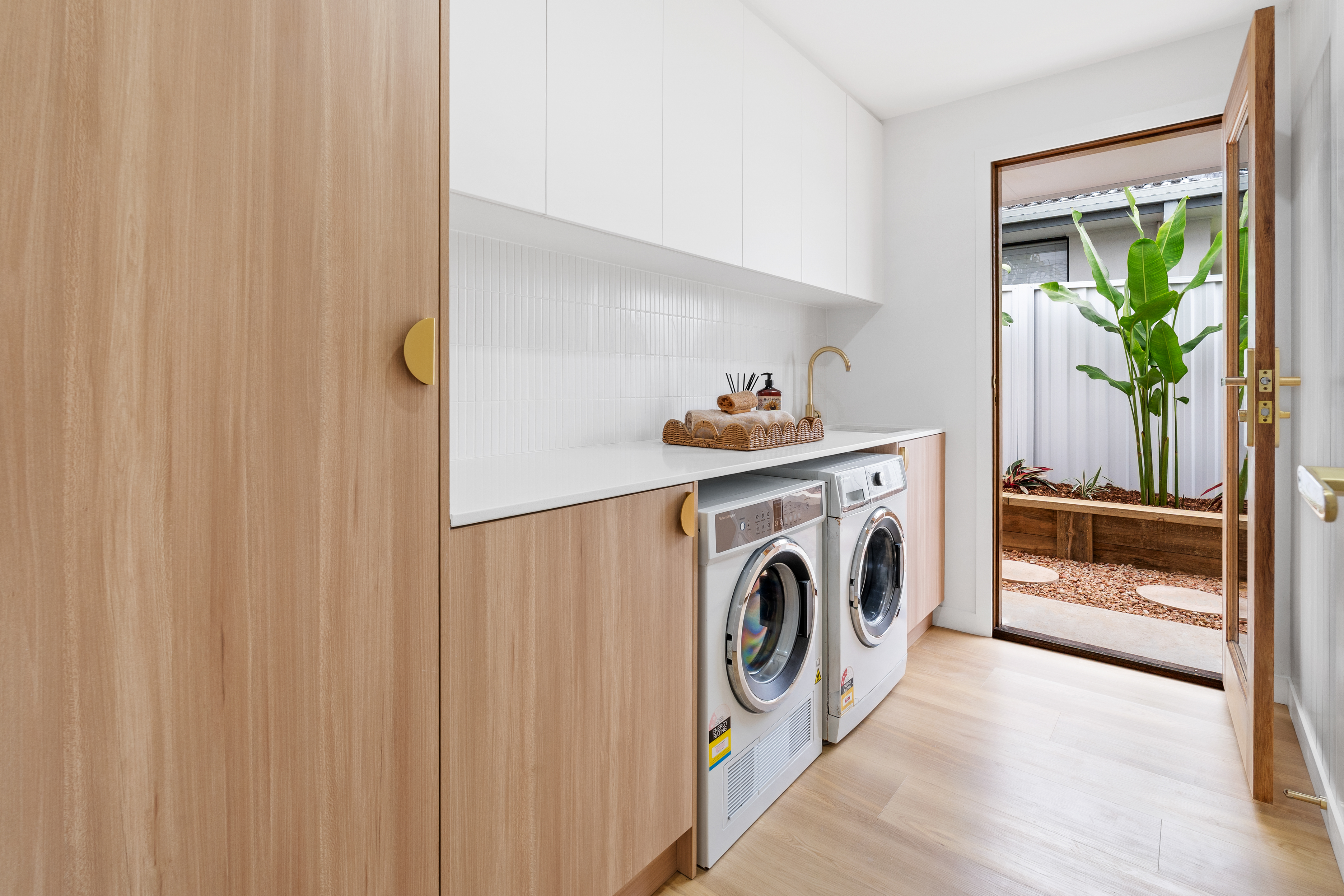 Modern laundry with timber cabinetry