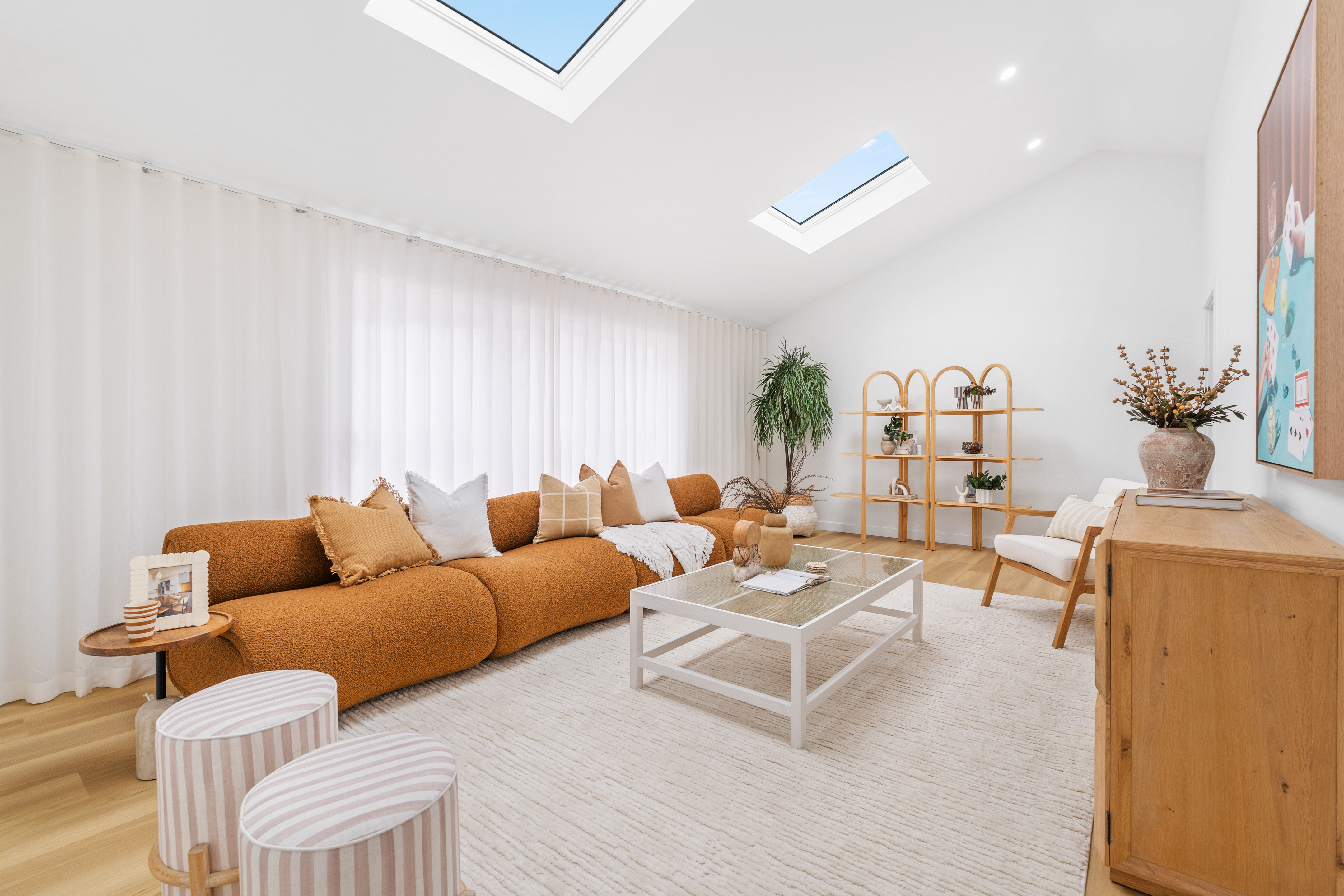 Modern living room with skylights and staged furniture