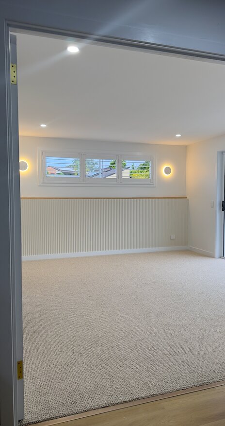 Bedroom with VJ panel feature wall and modern lighting